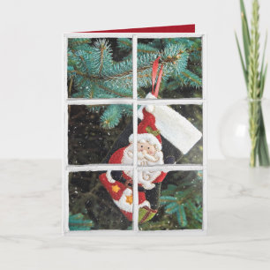 Jultomten i snöfönster helgkort