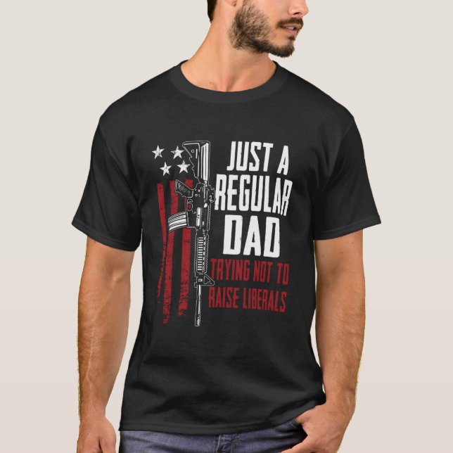 Just A Regular Dad Trying Not To Raise Liberals On T Shirt (Framsida)