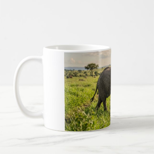 Kaffe kopp med baby elefant som går genom gräs (Vänster)