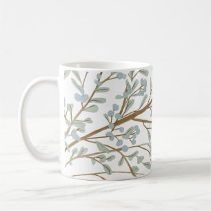 kaffe mugg med löv och träd grenar