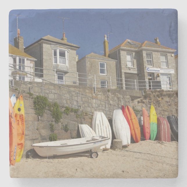 Kajaker och johannesbröd staplade mot havsvatten p underlägg sten (Framsidan)