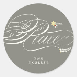 Kalligrafi av julfredskript, falsk helgeflastik runt klistermärke