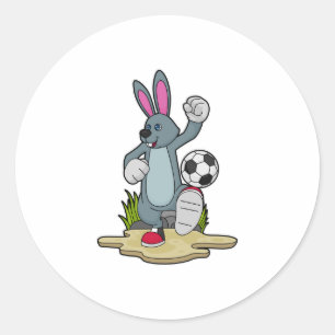 Kanin som fotbollsspelare med fotboll runt klistermärke