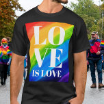 Kärlek är Kärlek Rainbow Pride T Shirt<br><div class="desc">Det här Pridet T-shirt är dekorerat med KÄRLEK IS KÄRLEK i fetstil,  vitt brev på en regnbågsbakgrund med vattenfärg: rött,  orange,  gult,  grönt,  blått och lila. Ursprunglig vattenfärg © Michele Davies.</div>