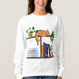 Katt Ljugande på en bokhylla, ett katt Bok och et T Shirt