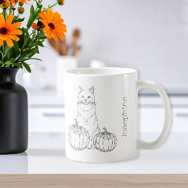Katt med pumpor med minimal avverkning av konst oc kaffemugg