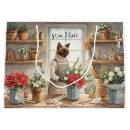 Katt som arrangerar vinterblommor för jul