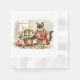 Katten arrangerar julblommor pappersservett