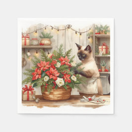 Katten arrangerar julblommor pappersservett