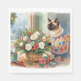 Katten arrangerar julblommor pappersservett