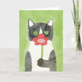 Katten med blomman noterar kortet kort