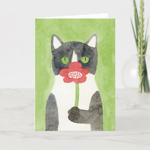 Katten med blomman noterar kortet kort