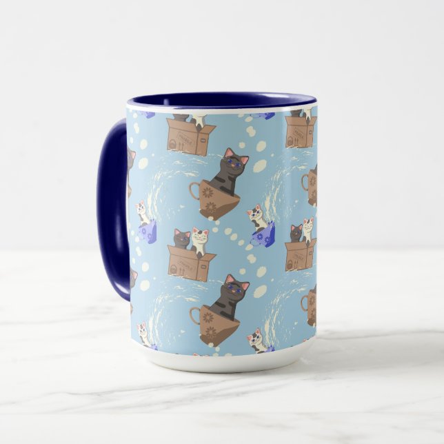Katter i låda och mjölk droppar i blått mugg (Framsida vänster)