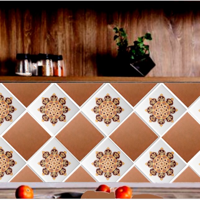 Keramiska plattor med medallionbrun, guld och oran kakelplatta (Medallion tiles with copper field tiles shown on a backsplash.)
