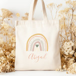 Kids Namn Boho Pastel Earth Tones Tygkasse<br><div class="desc">Den här tote-väskan har en boho-regnbåge som är dekorerad med ett hjärta och polka dots i muterade pastelljordtoner av guld,  terracotta,  beige,  dammig ro,  grönt och elfenben. Anpassa det med namn i terracotta handskript.</div>