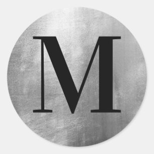 Klassisk svart monogram på falskt silverfolie runt klistermärke