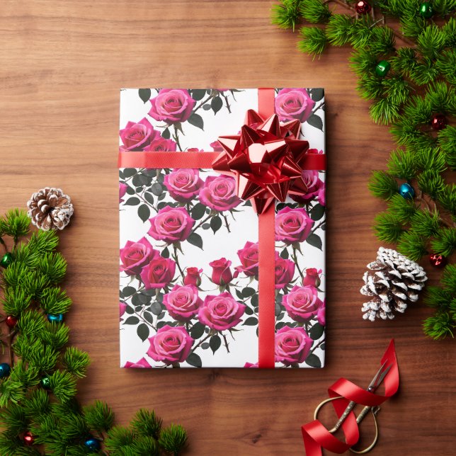Kluster av röda och rosa rosor på en skarp vit  presentpapper (Julgåva)