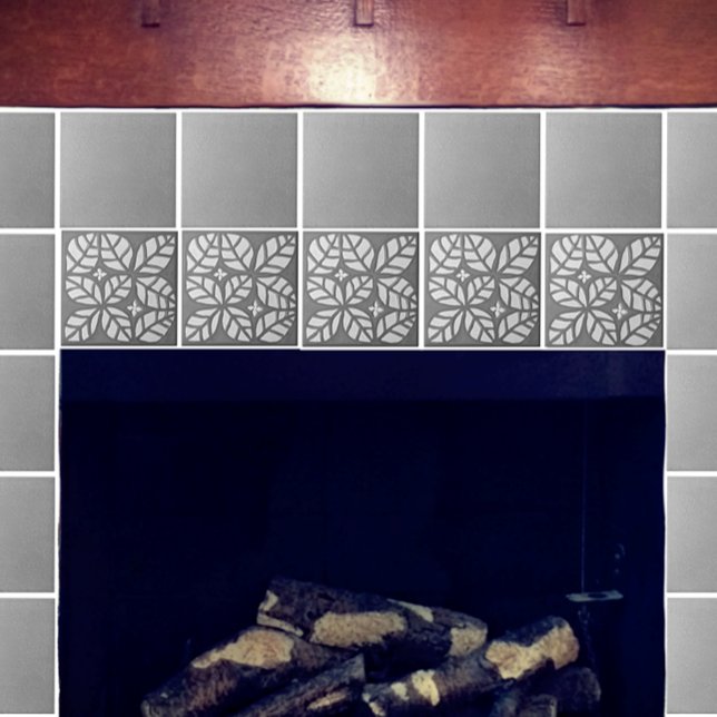 Köksbricka, Grått och vit ovat löv Kakelplatta (Gray and white Ovate tile with gray speckled. Shown on a fireplace.)