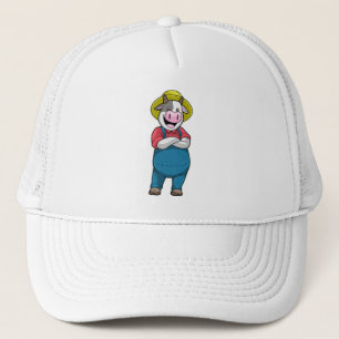Kon som jordbrukare med hatt keps