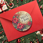 Kristus är född i Religiösan Poinsettia Runt Klistermärke<br><div class="desc">Fira Kristus födelse med den här eleganten vintage-stil juldekalen. Med klara röda poinsettias som omger det vackert skrivna meddelandet "CHRIST IS BORN", framkallar detta klistermärke säsongens värme och glädje. Designens mjuka, nedsänkta färg och klassiska charm gör det till en perfekt att lägga till en snygg beröring i presenter, kuvert eller...</div>
