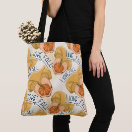 KVINNA I GULD SWEATER HOLDING TINY PUMPKIN TYGKASSE