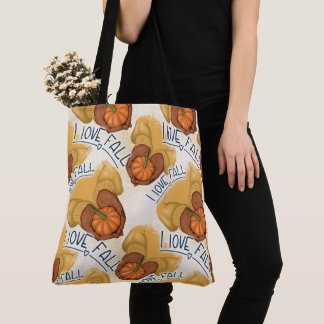 KVINNA I GULD SWEATER HOLDING TINY PUMPKIN TYGKASSE