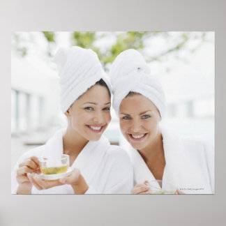 Kvinnor i badrockar som dricker te i spa poster
