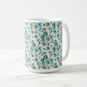 Kvistar med gröna blad och blå blommor. kaffemugg