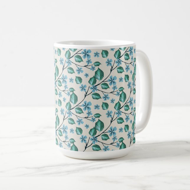 Kvistar med gröna blad och blå blommor. kaffemugg (Framsida höger)
