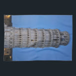 Leaning Tower at Dusk Kökshandduk<br><div class="desc">This captivating photograph showcases the iconic Leaning Tower of Pisa standing elegantly against a deep blue twilight sky in Pisa. The historic marble tower, famous for its unmistakable tilt, is beautifully illuminated, highlighting its intricate Romanesque arches and layered columns. The soft evening light creates a striking contrast between the glowing...</div>