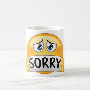 Ledsen ledsen Emoji-ansikte som håller ett ursäktt Kaffemugg