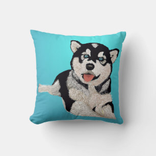 Lekande av Bright Husky Puppy mot Vacker Aqua Kudde