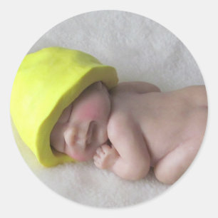 Lerababy som sovar på tummyen, älvahatt, skulptu runt klistermärke