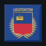 Liechtenstein Flagga Shield Magnet<br><div class="desc">Liechtensteins nationella flagga infiltreras i ett faux guld-skölsystem som sätts på Faux guld löv.</div>