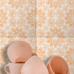 Light Orange White Ornate Symmetrical Geometric Kakelplatta<br><div class="desc">Den keramiska plattan har en komplicerad design som är både symmetrisk och sofistikerad. Utformningen kännetecknas av ornat, vit blommigt och geometriska former som kontrasterar vackert mot en varm bakgrund med persikofärgad färgad. Plattans utformning är centrerad kring ett diamantformat inslag, omgivet av eleganter och kurvor. Detta centrala motiv kompletteras av en...</div>