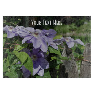 Lila Clematis Flowers på stängslet