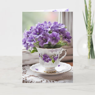 Lila violer blommar i tekopp helgkort