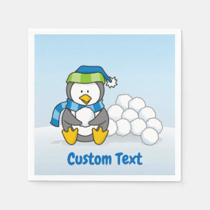 Lilla penguin sitta med papper napkin med snöbull pappersservett