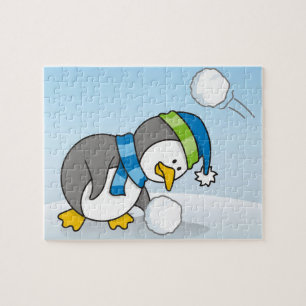 Lilla penguin som får snö boll pussel
