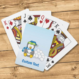 Lite penguin sitta med snöbollar som spelar kort casinokort