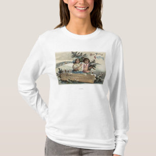 Liten flickainnehav en gåva och ett träd t shirt