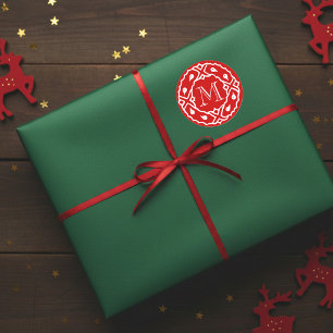 Liten julklapp med andningsmonogram runt klistermärke
