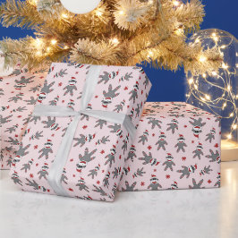 Liten strumpmonkey med jultomtehatt rosa jul presentpapper