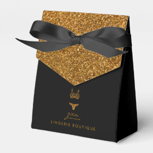 Liten svart presentask med guldglittrig logotyp