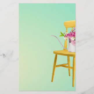 Ljus gul stol med att bevattna canen av blommor brevpapper