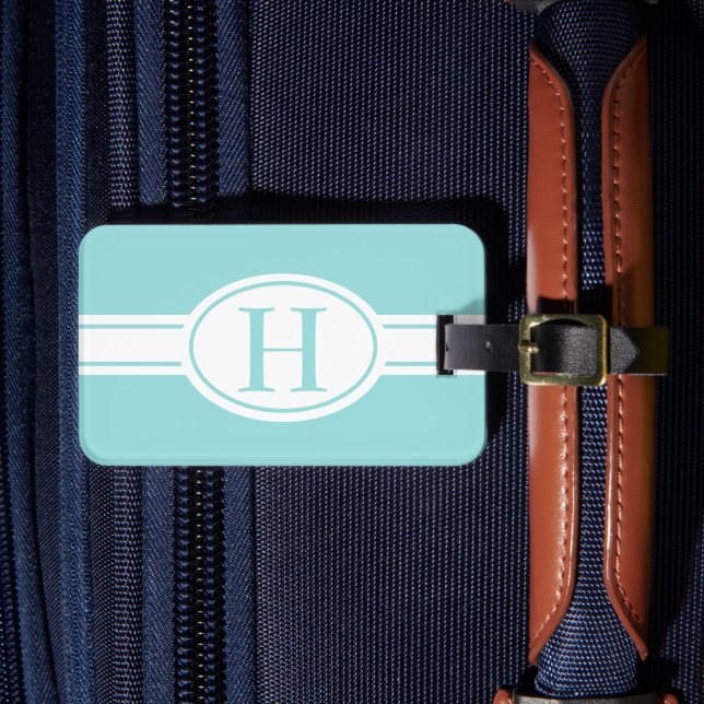 Ljusblått monogram av vit bandets oval bagagebricka (Framsida Insitu 4)