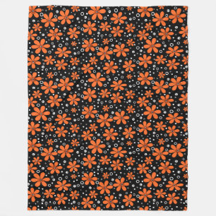 Ljusstark orange blommar på svart bakgrund med w fleecefilt