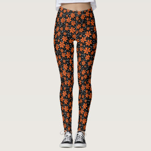 Ljusstark orange blommar på svart bakgrund med w leggings