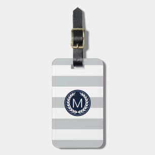 Ljust - grå rand med monogramen för bagagebricka