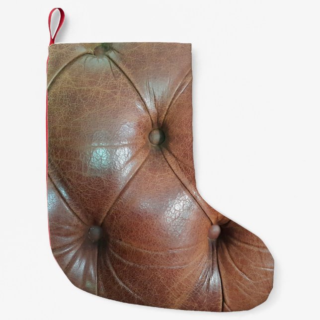 Ljust på brunt läder soffa yta, textureabstra liten julstrumpa (Framsidan)
